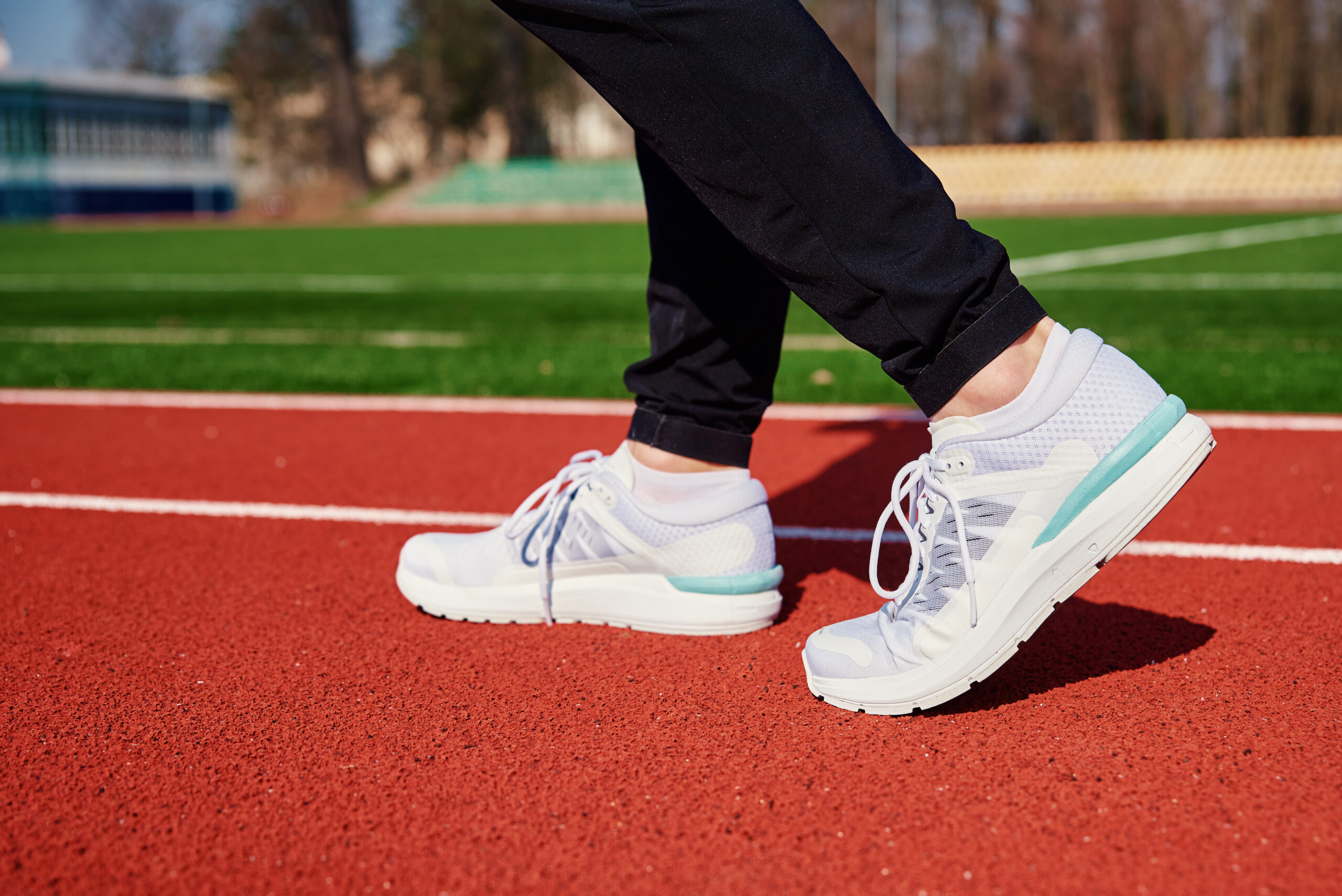 Runner feet running at sport stadium track