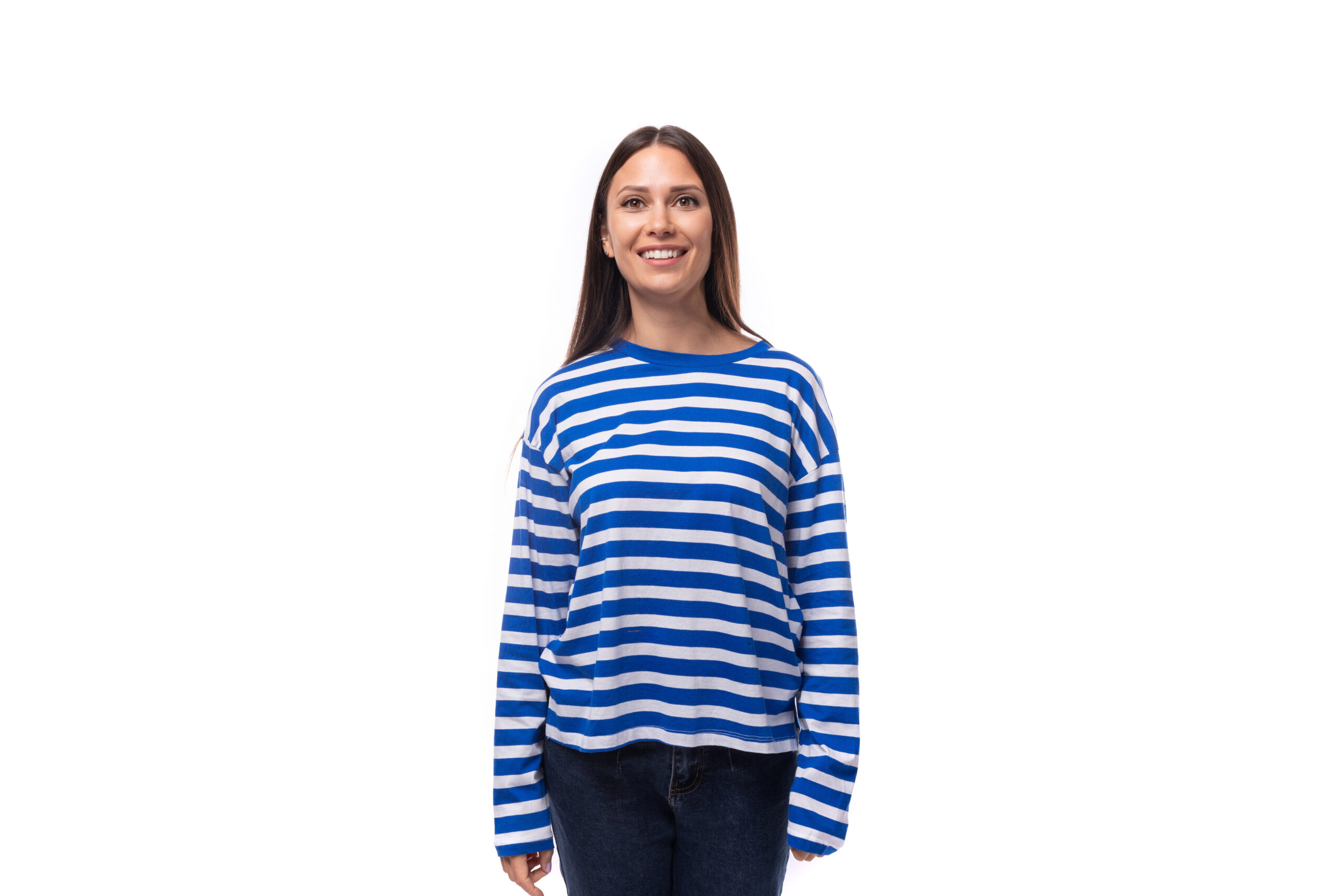 young slender european brunette woman dressed in a striped blue sweater on a white background