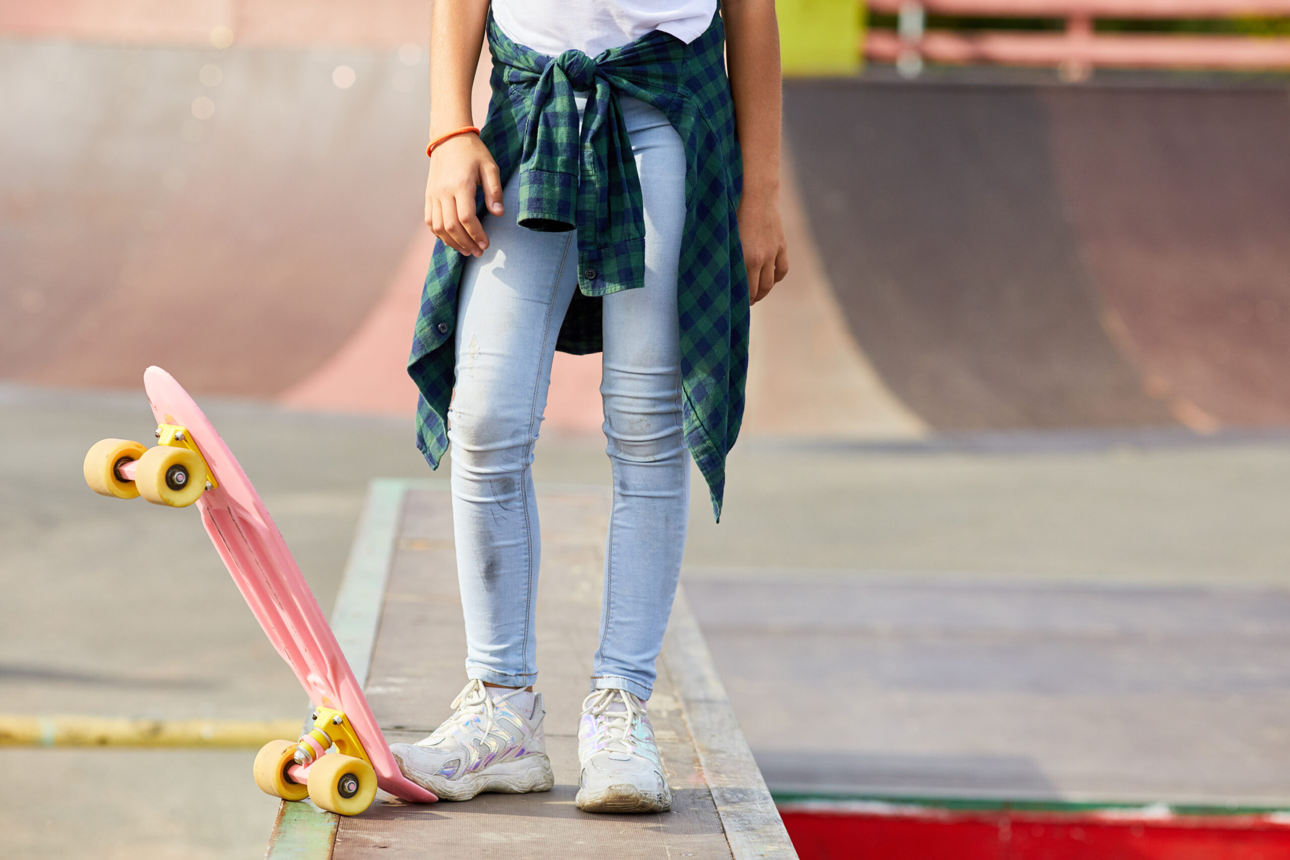 Girl with skateboard outdoors