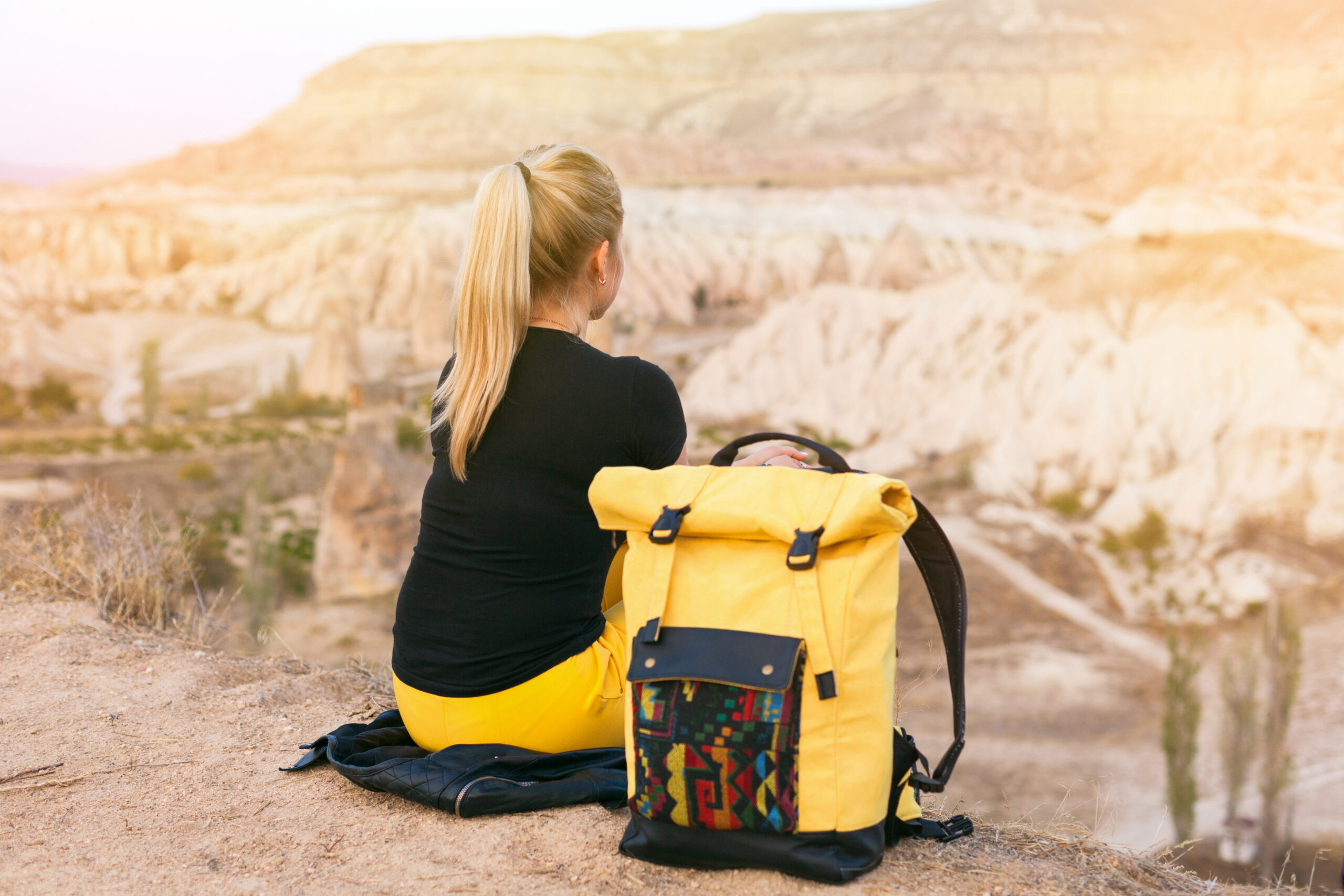 Blond hair woman with yellow authentic backpack