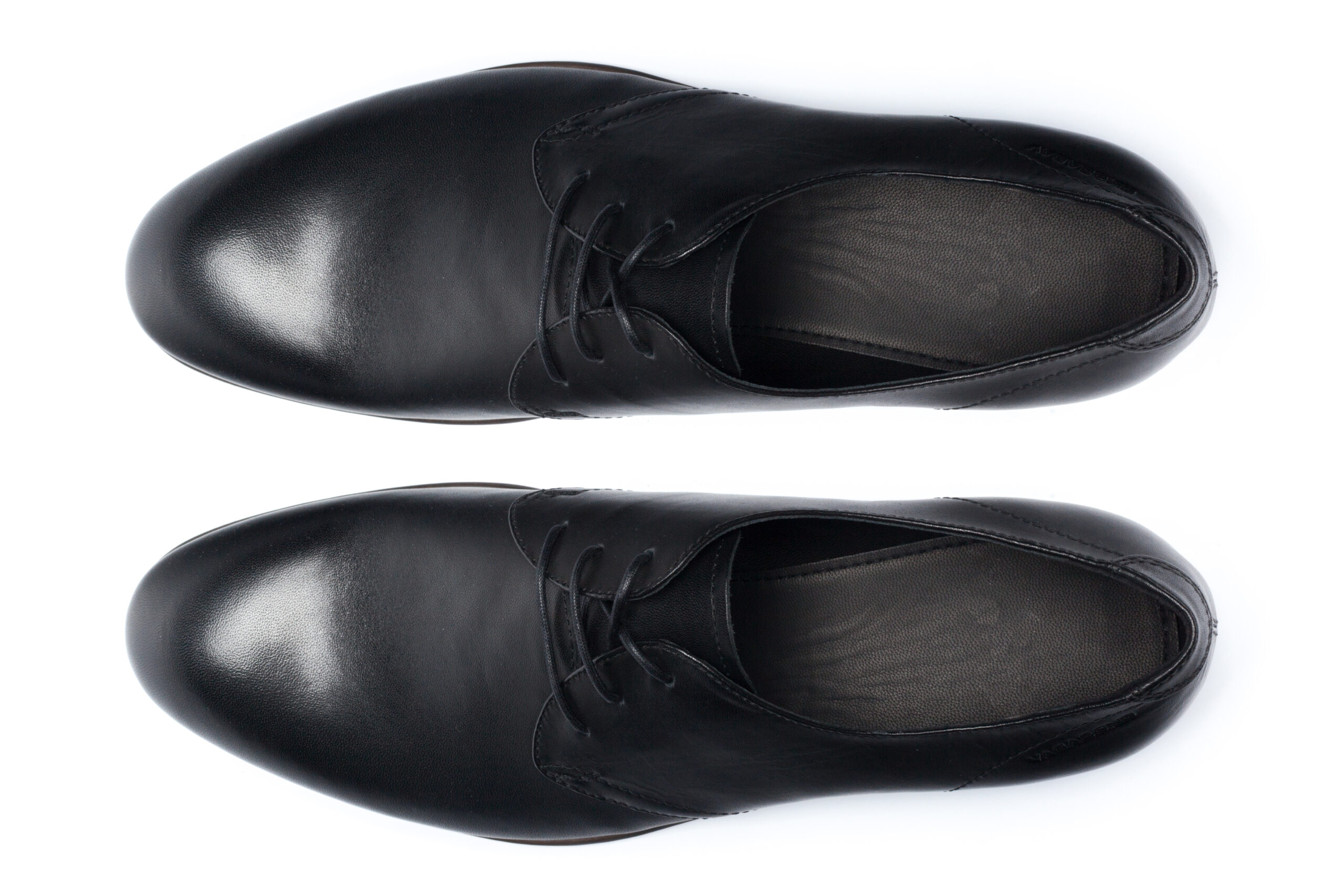 Classic male leather shoes isolated on a white, top view.