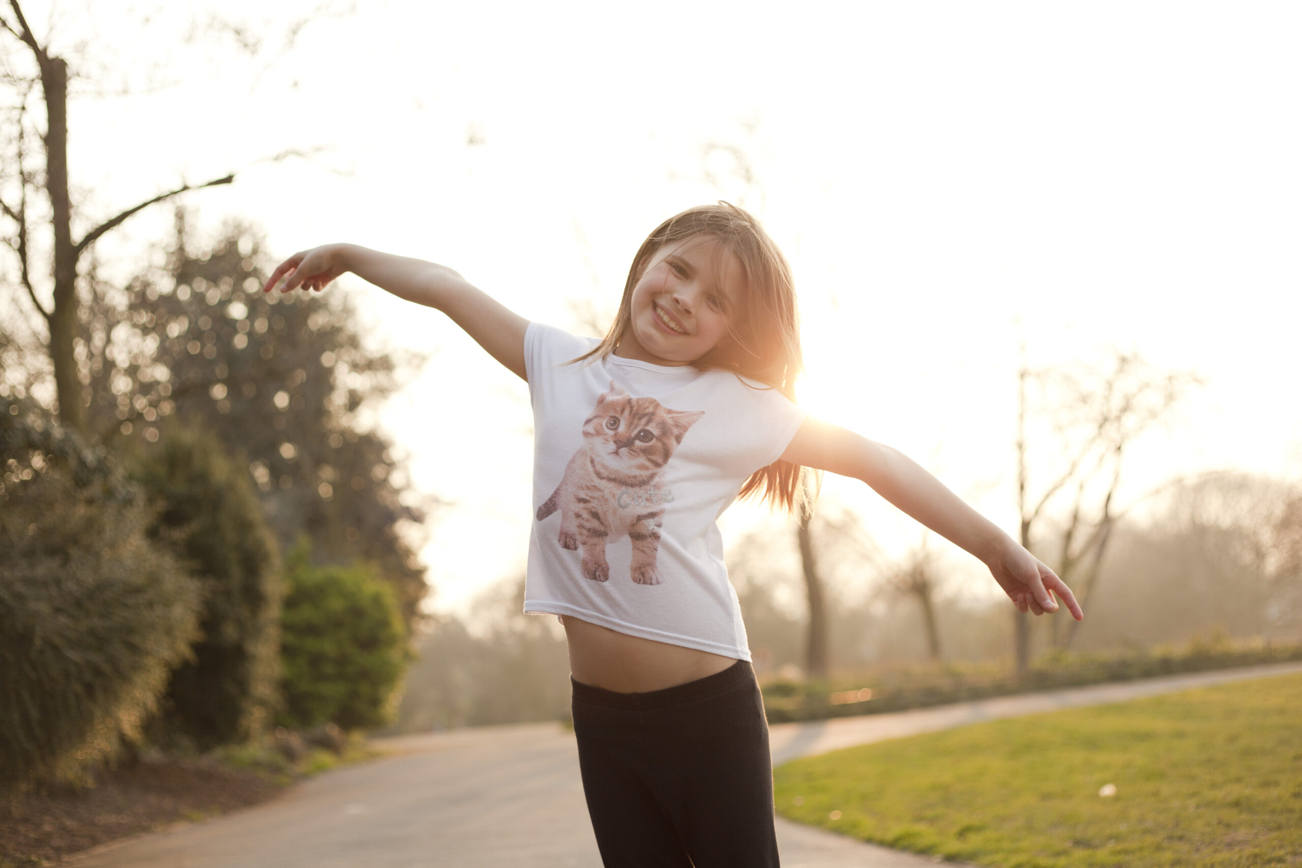 Portrait of young girl in park, smiling